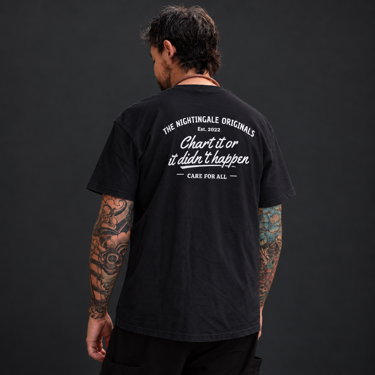 Back view of a black Chart’d T-shirt showing the Chart it or it didn’t happen and Care for All print.
