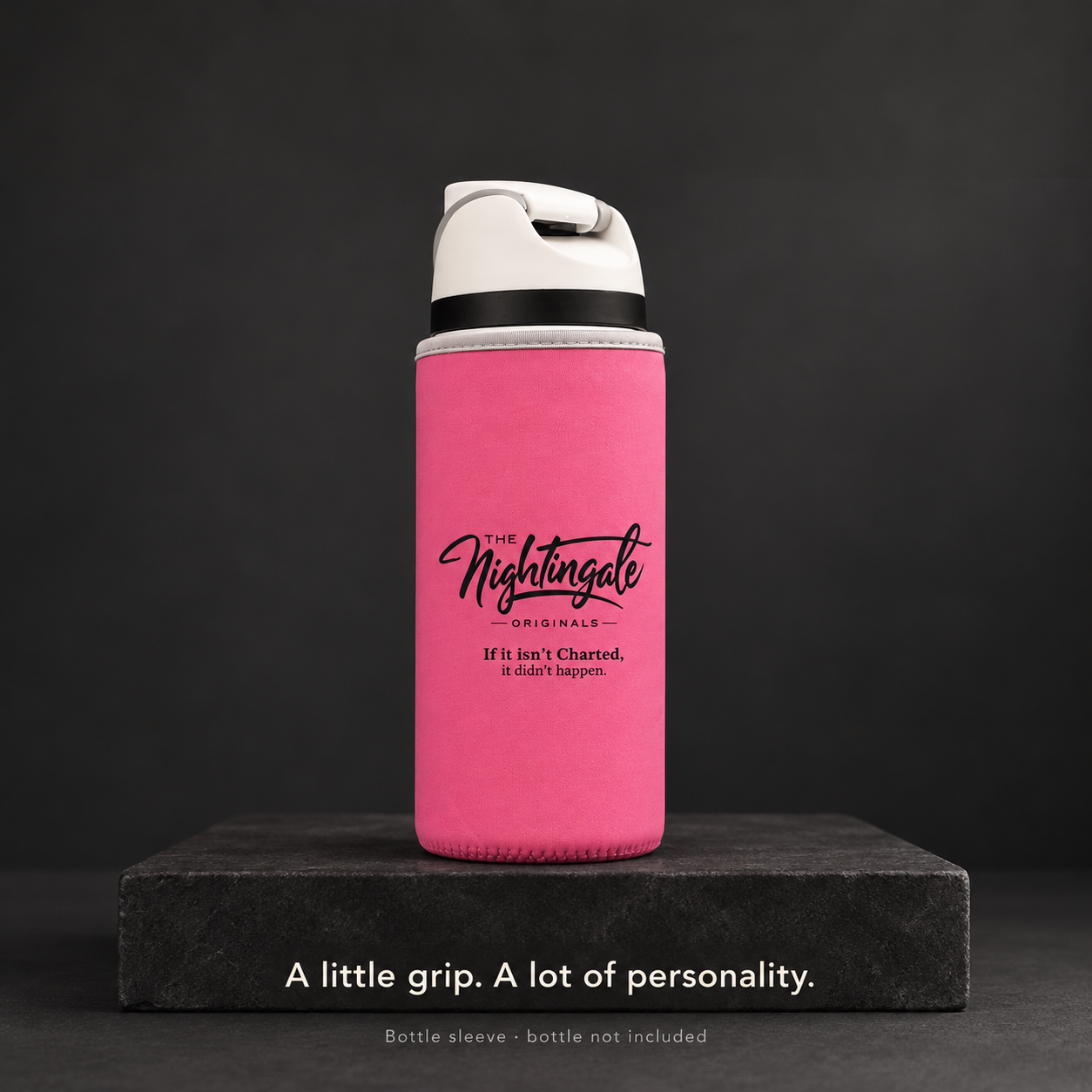 Rose-pink Clutch’d sleeve fitted around a tumbler on a dark stone display with Nightingale Originals branding.