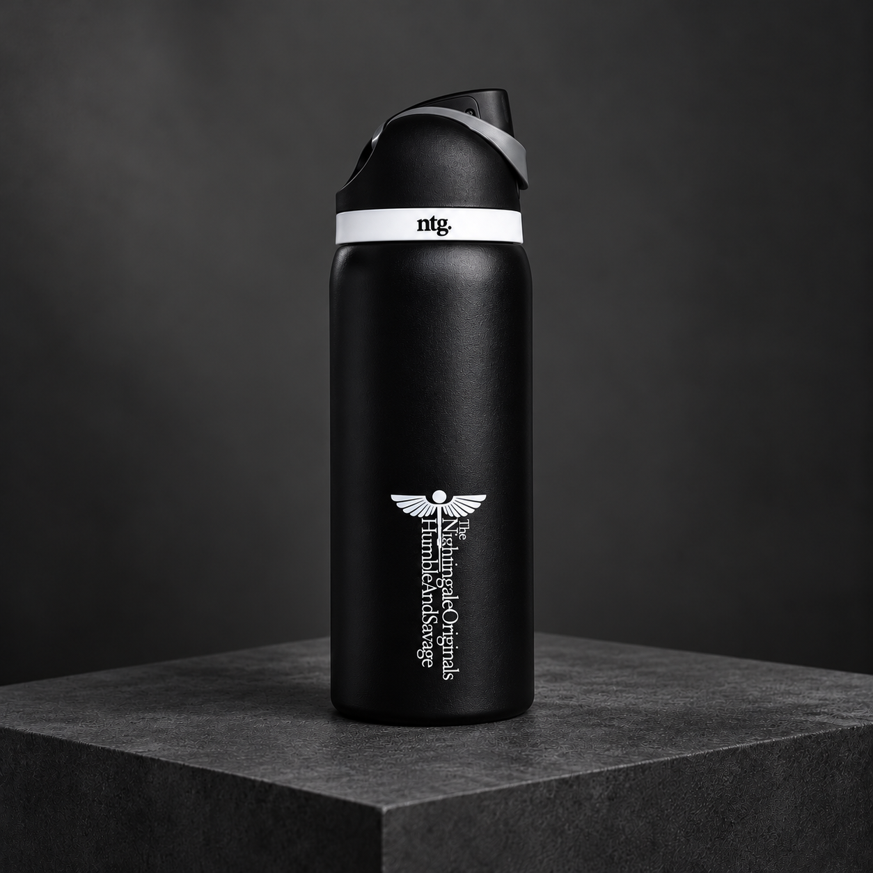 Black Parch’d tumbler with its drinking spout open, displayed on dark stone.